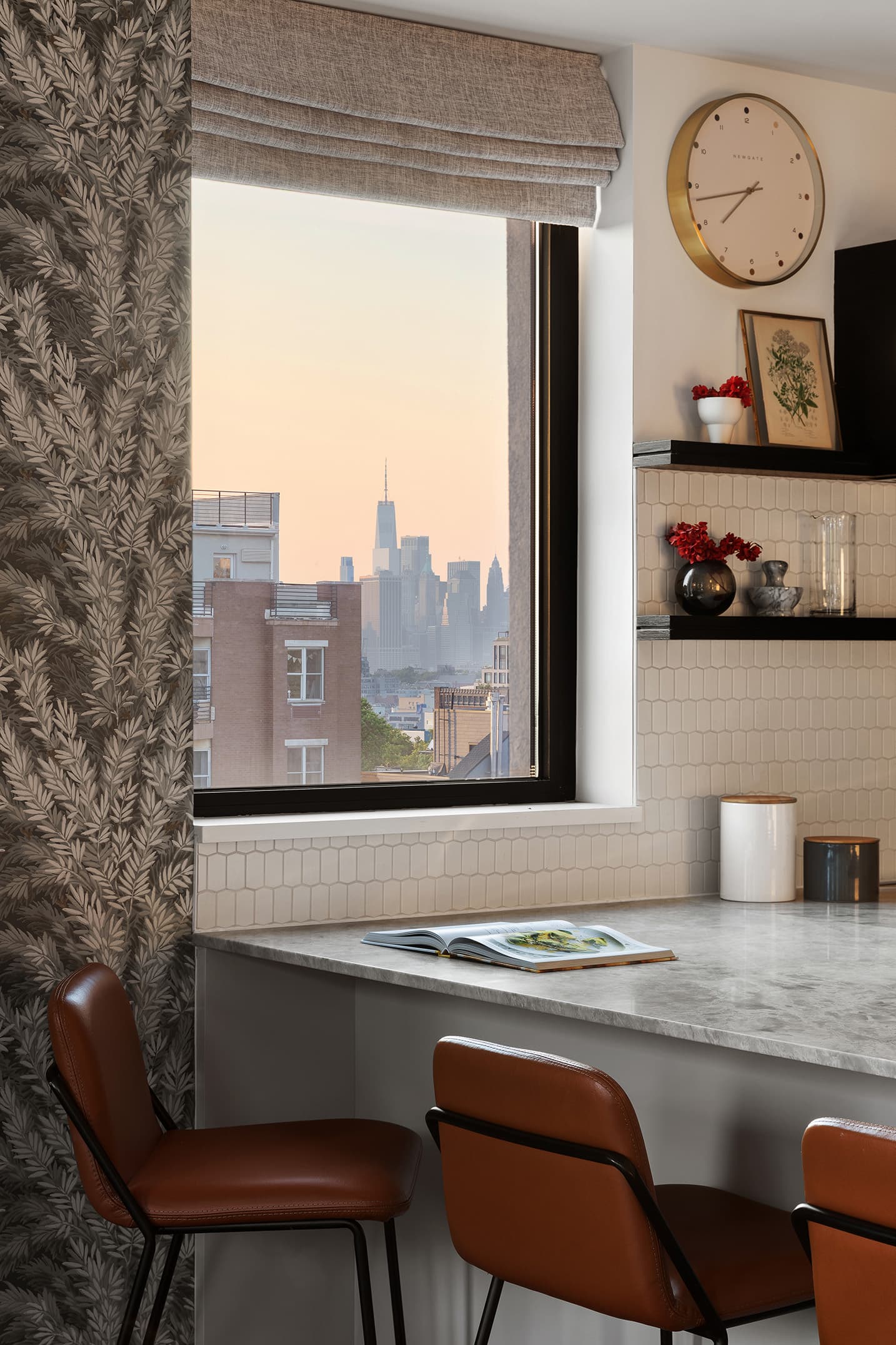 A dining table set against a window over the city